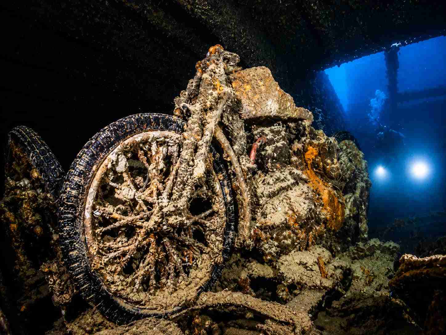 Motorcycles stacked inside a truck bed in a cargo hold