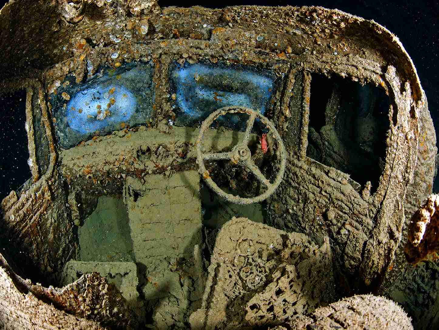 Truck cab with its steering wheel inside a cargo hold
