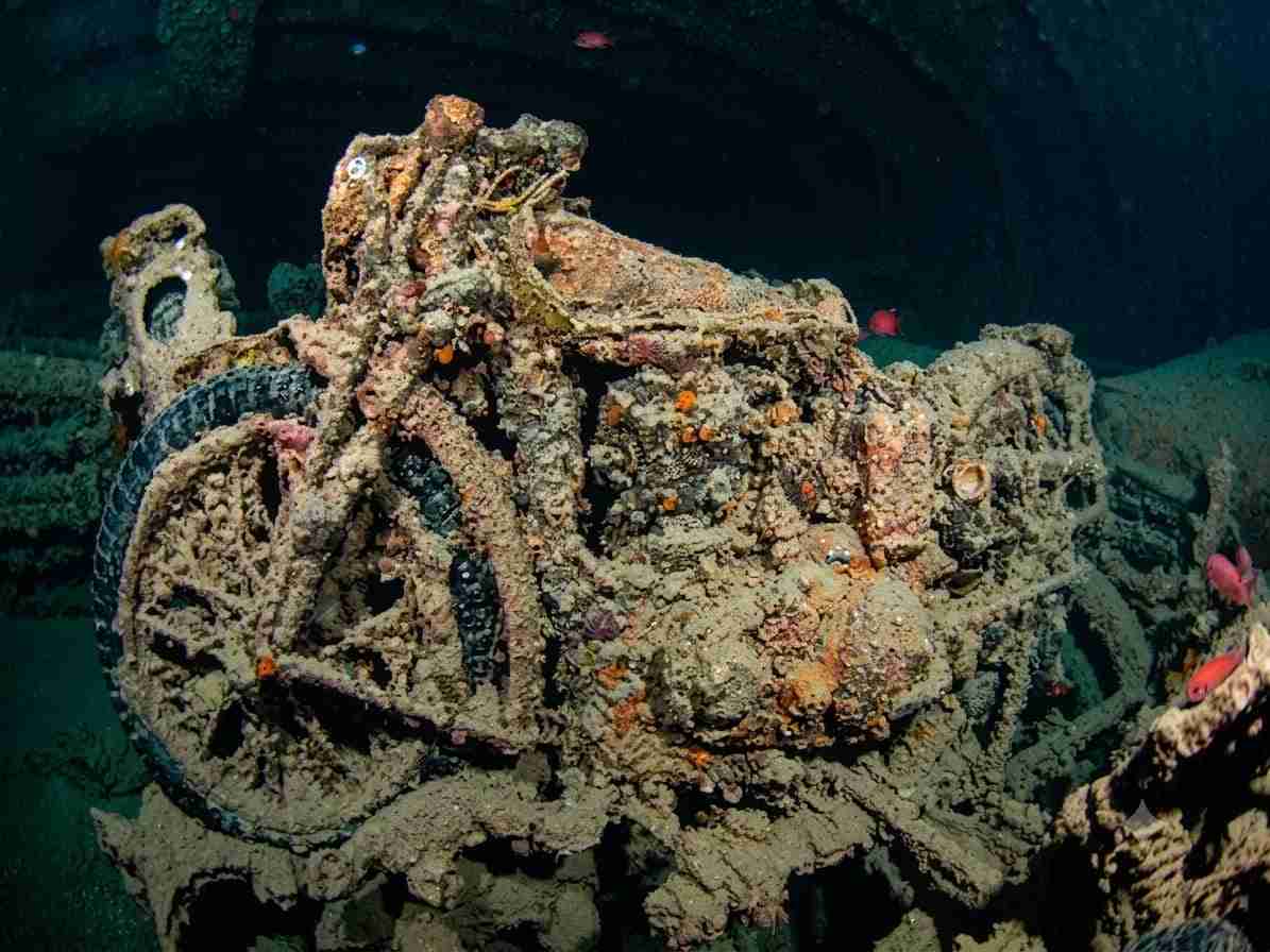 Motorcycles stacked in a lit cargo hold