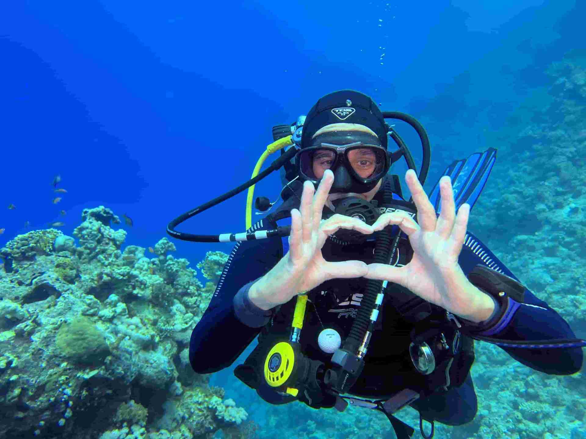 Diver over a coral garden in the shallows